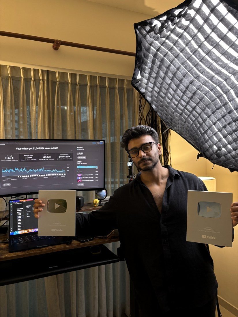 Alex, founder of YTVideos.io, holding two YouTube play button awards